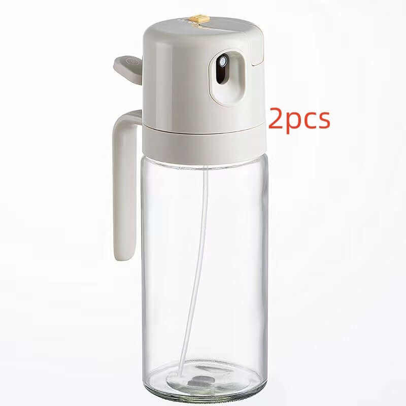 Clear kitchen oil sprayer bottle with white handle and text &