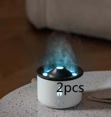 Small white tabletop humidifier with LED lights emitting cool mist, 2 pieces included