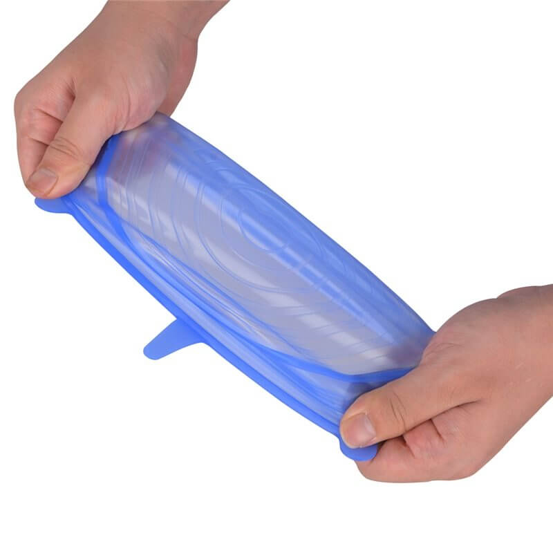 Hands stretching a blue reusable silicone food storage bag