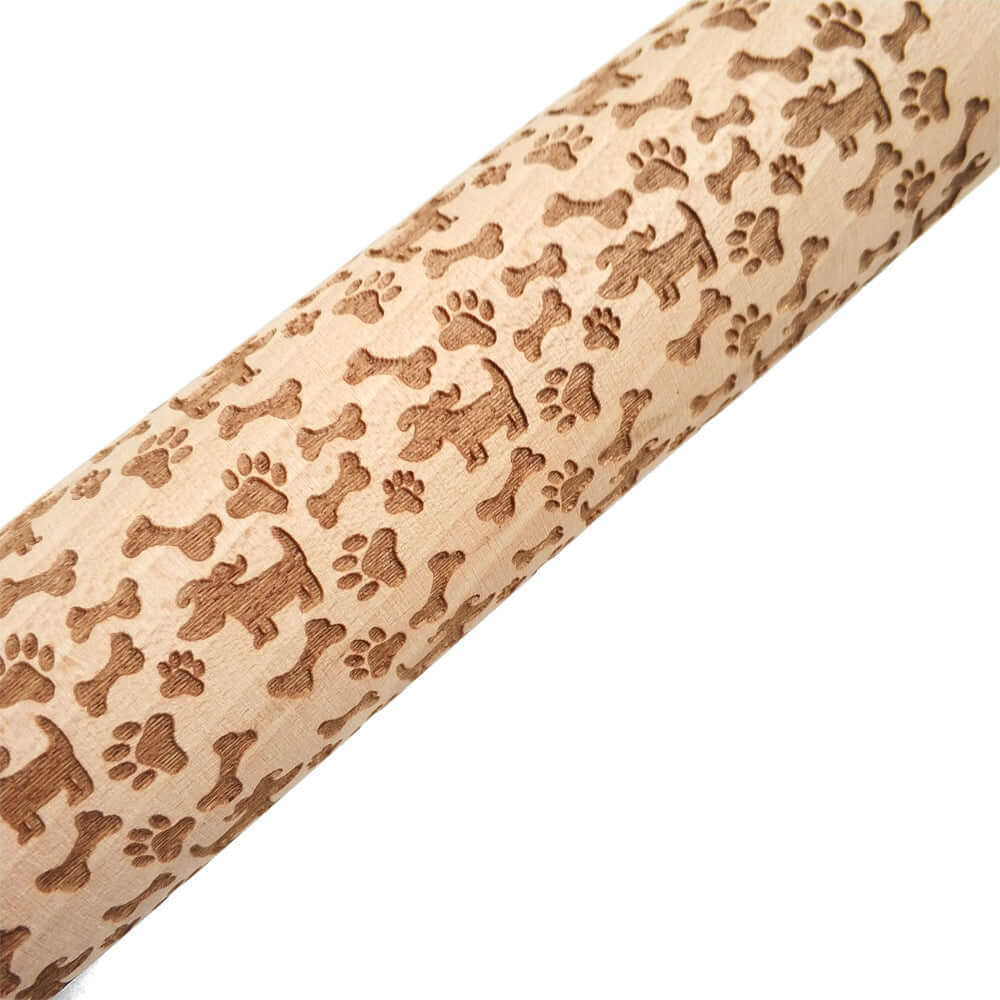 Wooden rolling pin with embossed dog, bone, and paw print patterns for baking cookies