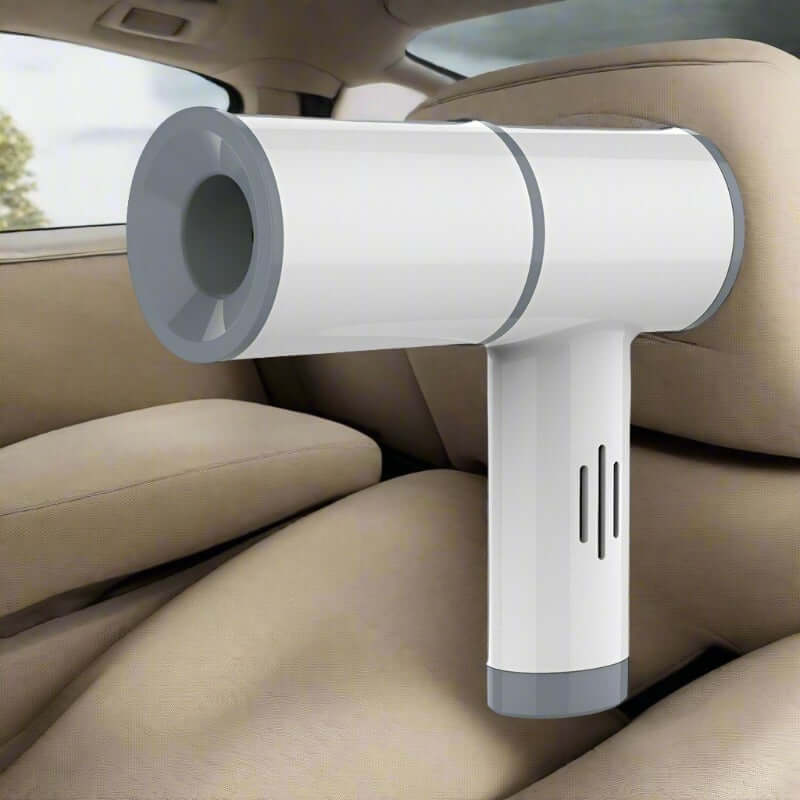 White handheld cordless vacuum cleaner for car interior, compact modern design on tan seats