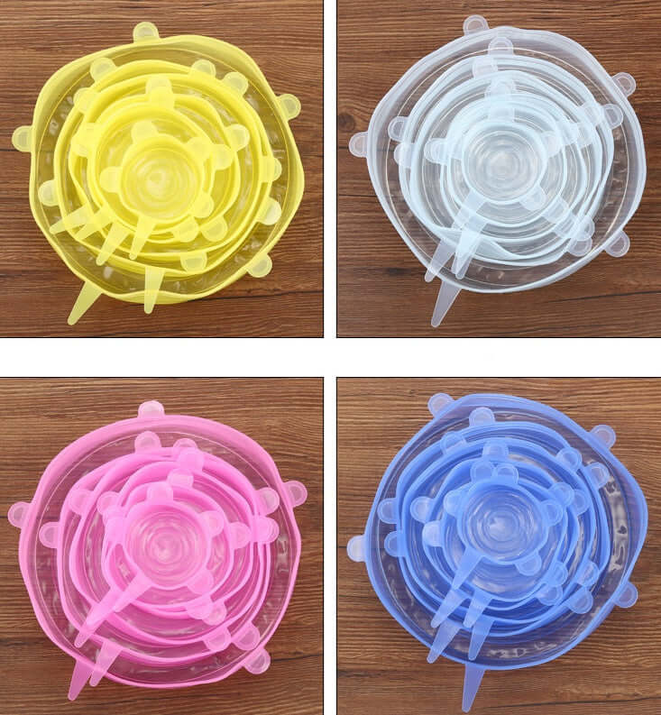 Four sets of reusable silicone stretch lids in yellow, clear, pink, and blue on wooden surface