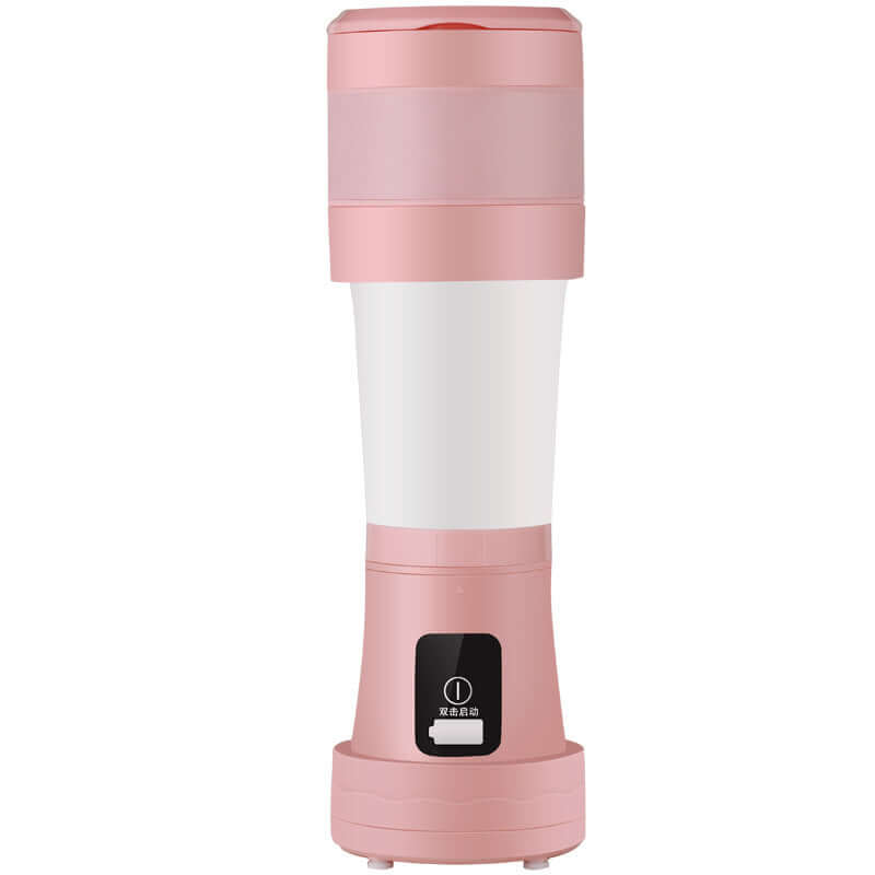 Pink portable blender cup kitchen appliance with lid and power button, isolated on white background