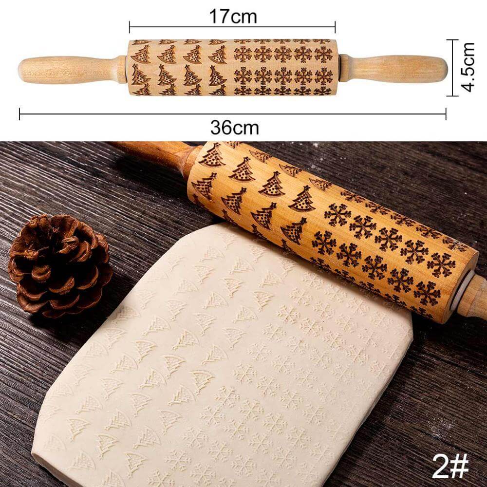 Wooden embossed rolling pin with tree and snowflake pattern, shown imprinting dough.