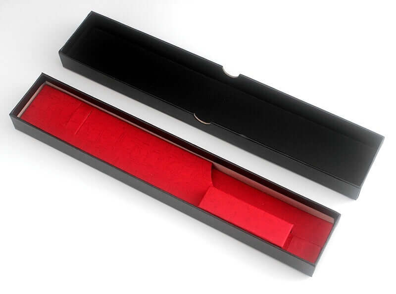 Black rectangular knife gift box with red velvet interior, open and empty