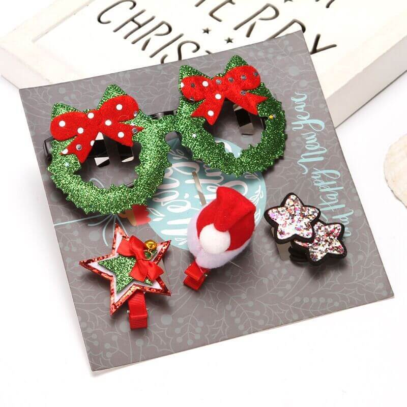Set of Christmas-themed hair clips with glitter, including wreath, star, and Santa hat designs