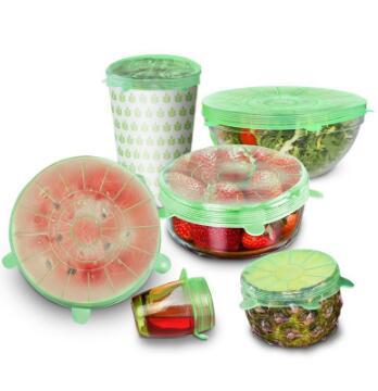 Reusable silicone stretch lids on various kitchen containers with fruits and vegetables
