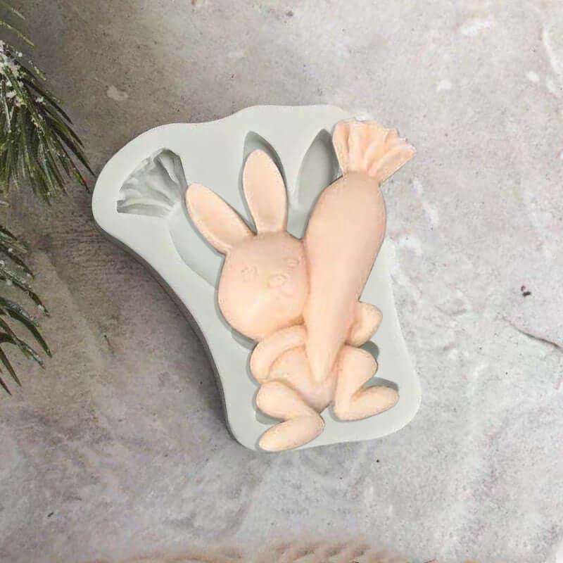 Silicone mold for baking featuring a bunny holding a carrot, kitchen accessory on table