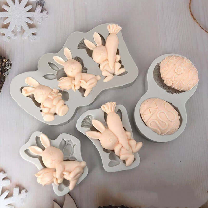 Silicone baking molds with bunny and carrot designs, ideal for Easter treats or cake decorating.