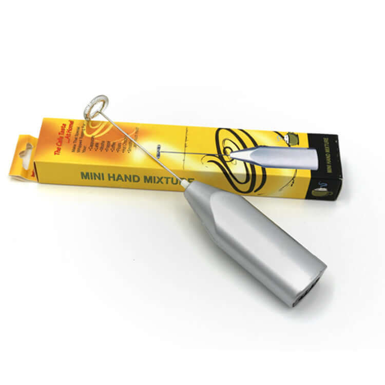 Silver mini hand mixer with whisk, shown next to yellow product box on white background