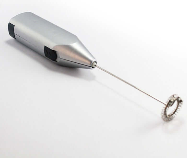 Stainless steel handheld milk frother for coffee and kitchen use on white background