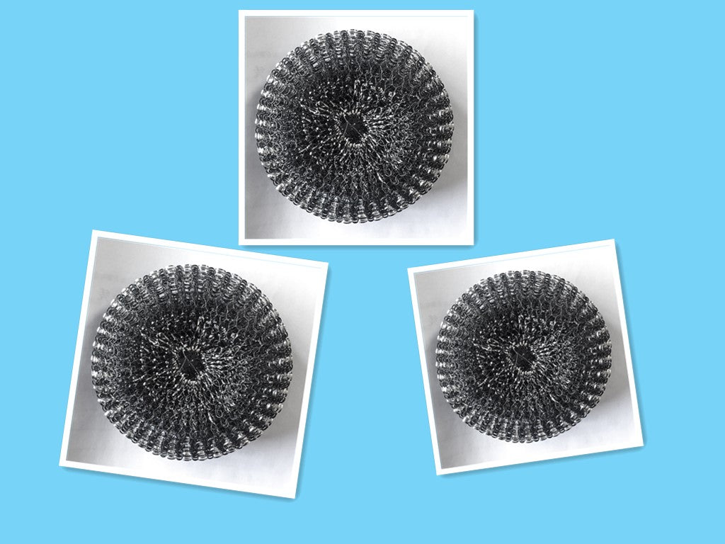Three round metal kitchen scrubbers on white background with blue backdrop