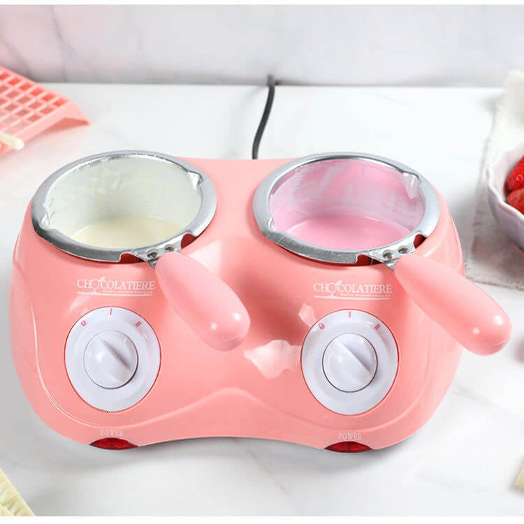 Dual pink chocolate melting pot with two handles, white and pink chocolate inside
