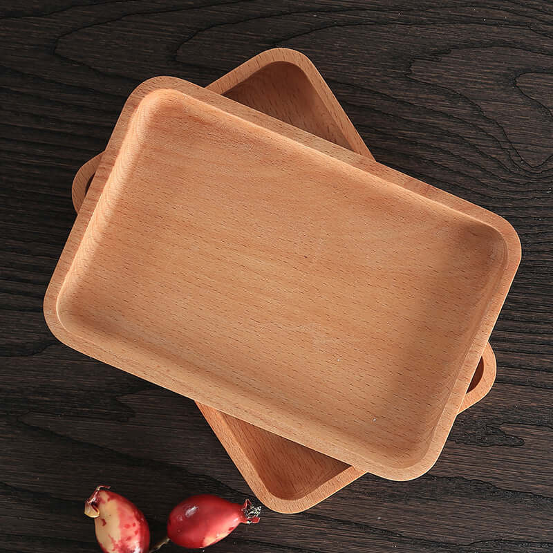 Stacked rectangular wooden serving trays on dark table, rustic kitchen accessory