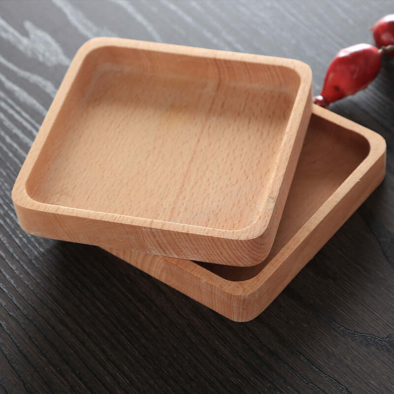 Square wooden trays for kitchen use on a dark wood table