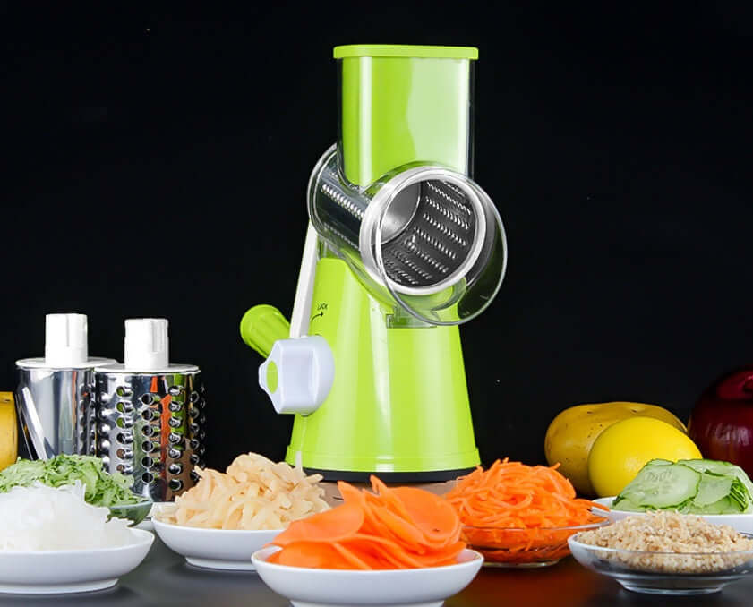 Manual rotary vegetable slicer with stainless steel blades surrounded by sliced vegetables