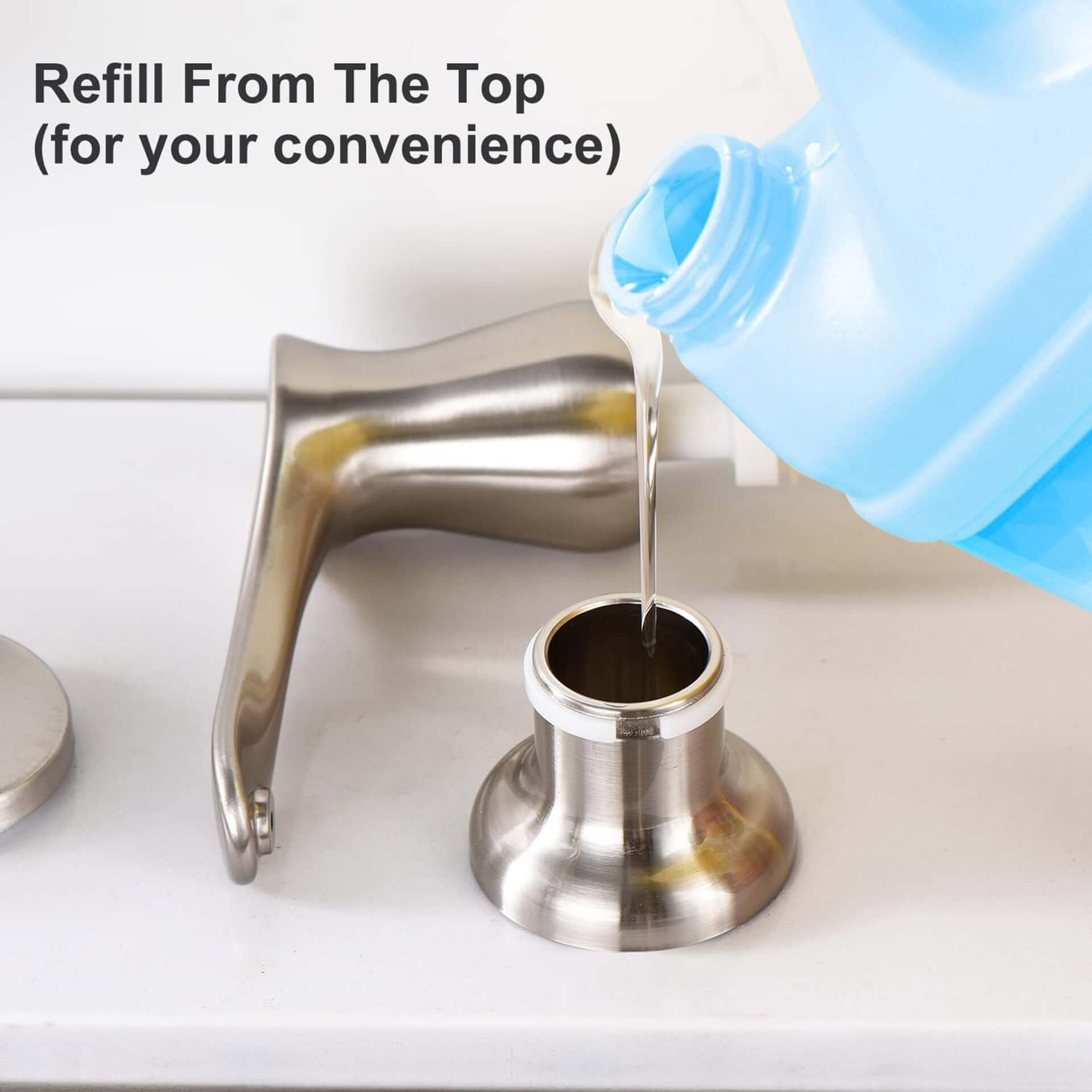 Stainless steel kitchen soap dispenser being refilled from the top with liquid