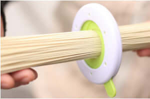Chopstick portion control tool measuring a bundle of uncooked spaghetti noodles