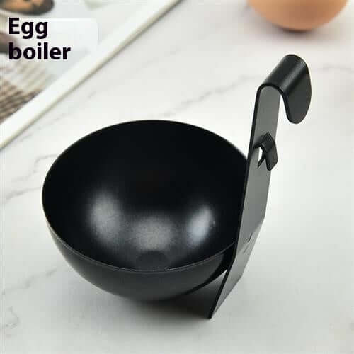 Black egg boiler cup with handle on a white kitchen countertop