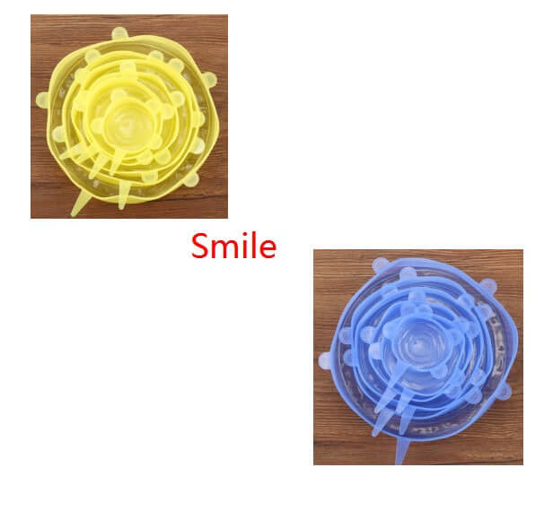 Yellow and blue silicone stretch lids in various sizes on wooden surface, kitchen accessories.
