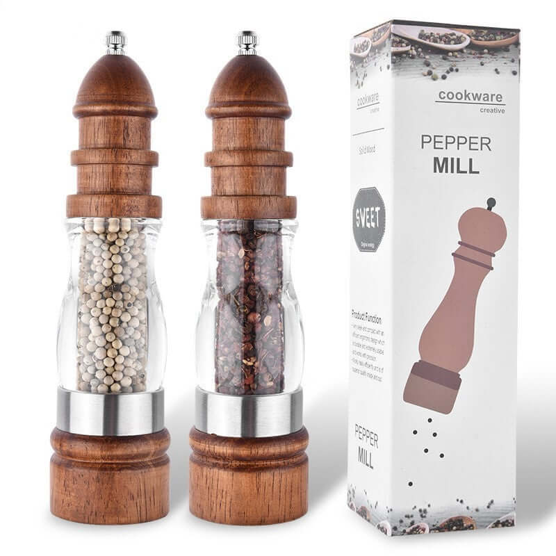 Wood and glass pepper mills with spices, next to product packaging, kitchen accessories
