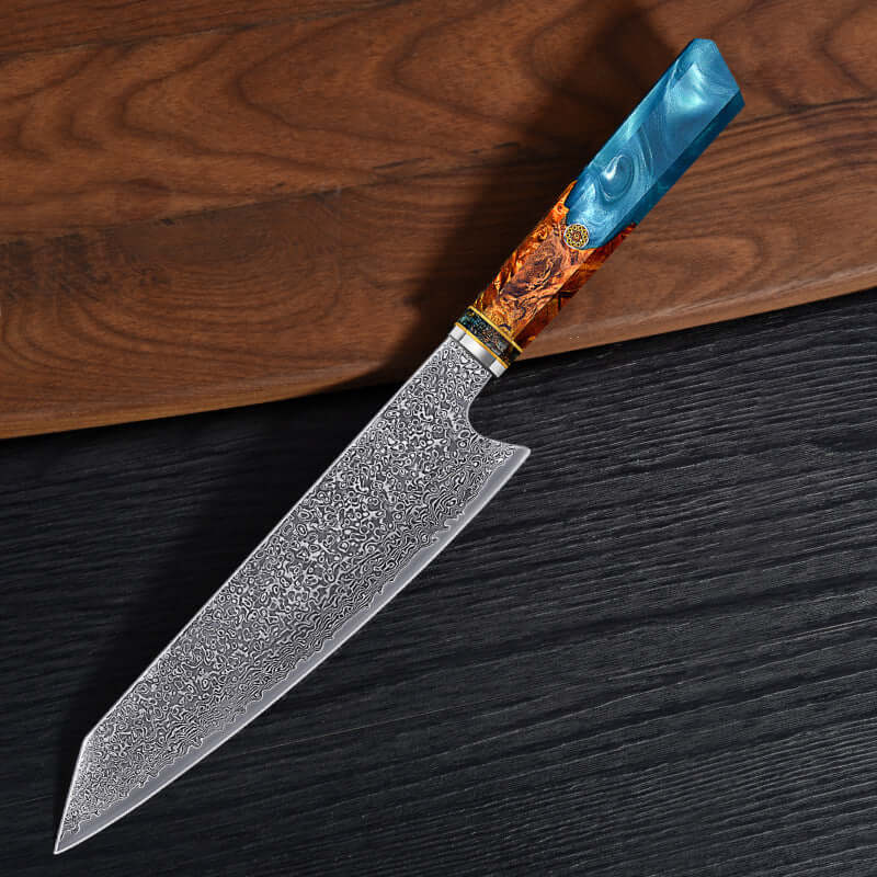 Damascus steel chef knife with blue and wood resin handle on dark wood surface