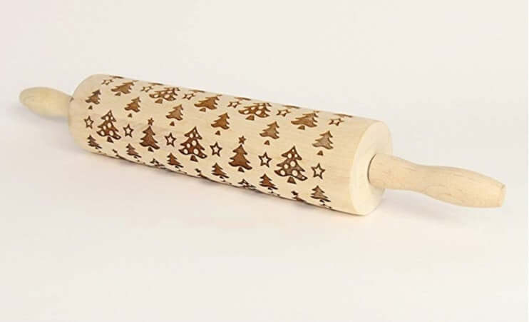 Wooden rolling pin with engraved Christmas tree and star pattern for baking