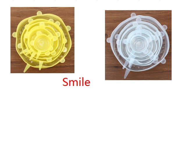 Reusable silicone stretch lids in yellow and clear, nested on a wooden surface