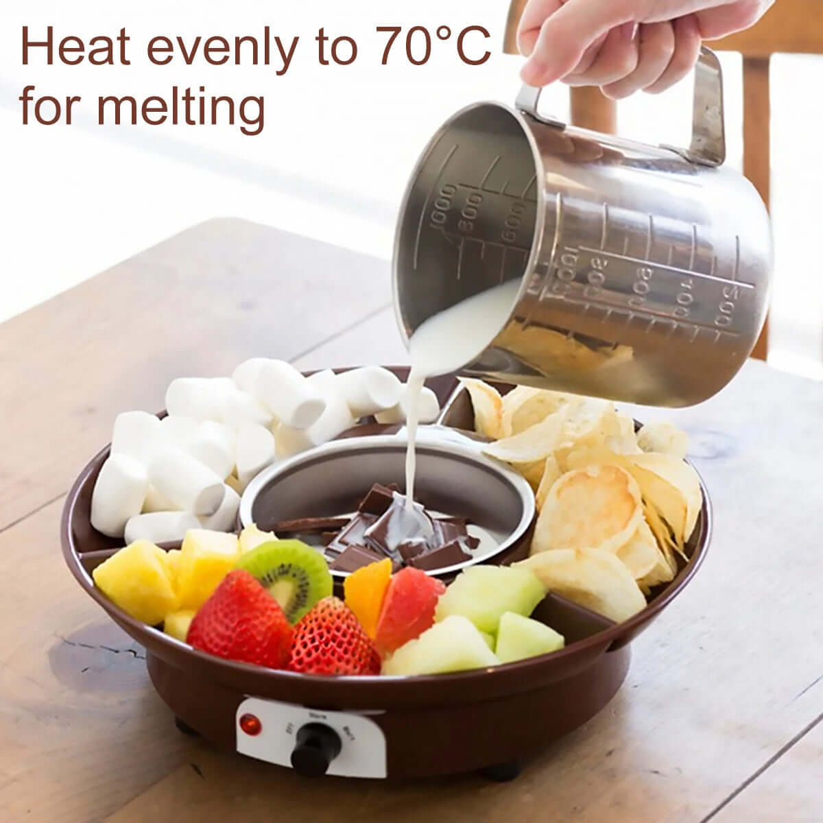 Electric chocolate fondue pot for melting, surrounded by fruit, marshmallows, and chips.