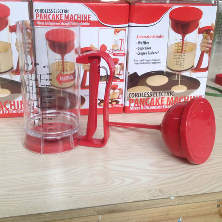 Cordless electric pancake batter dispenser and mixer on a kitchen counter