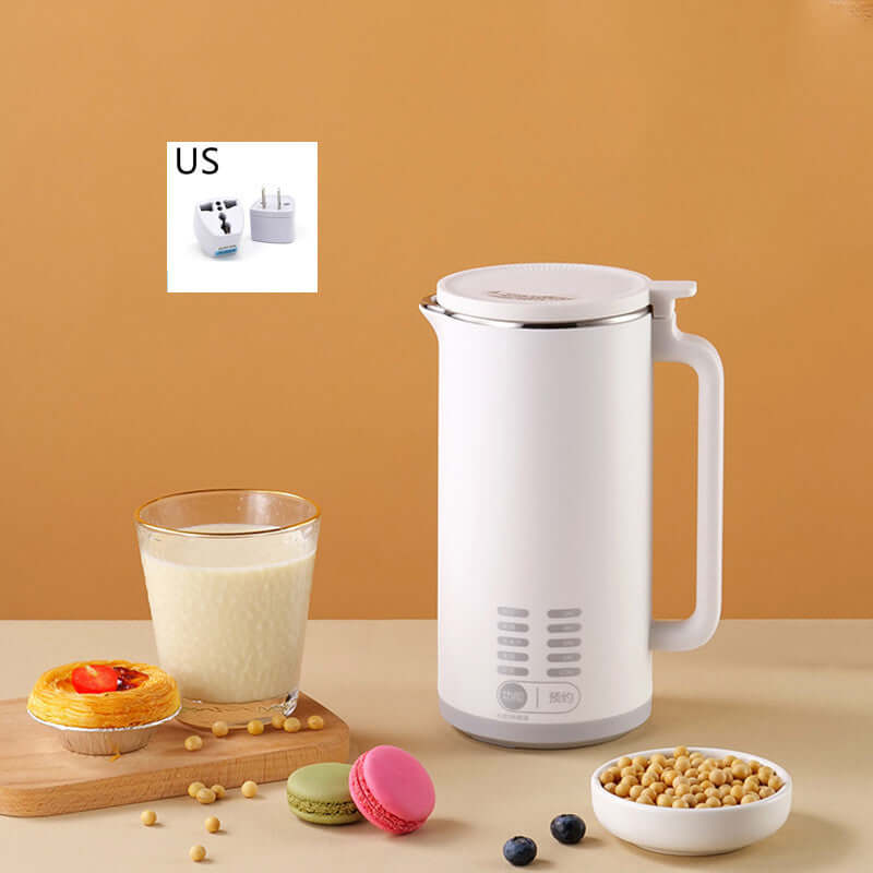 Electric soy milk maker with glass of soy milk, dessert, macarons, soybeans, and US plug adapter