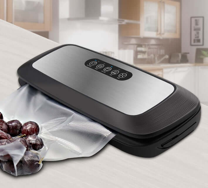Vacuum sealer machine sealing grapes in bag on kitchen countertop