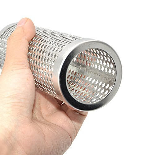 Hand holding a stainless steel mesh tube for kitchen or cooking use