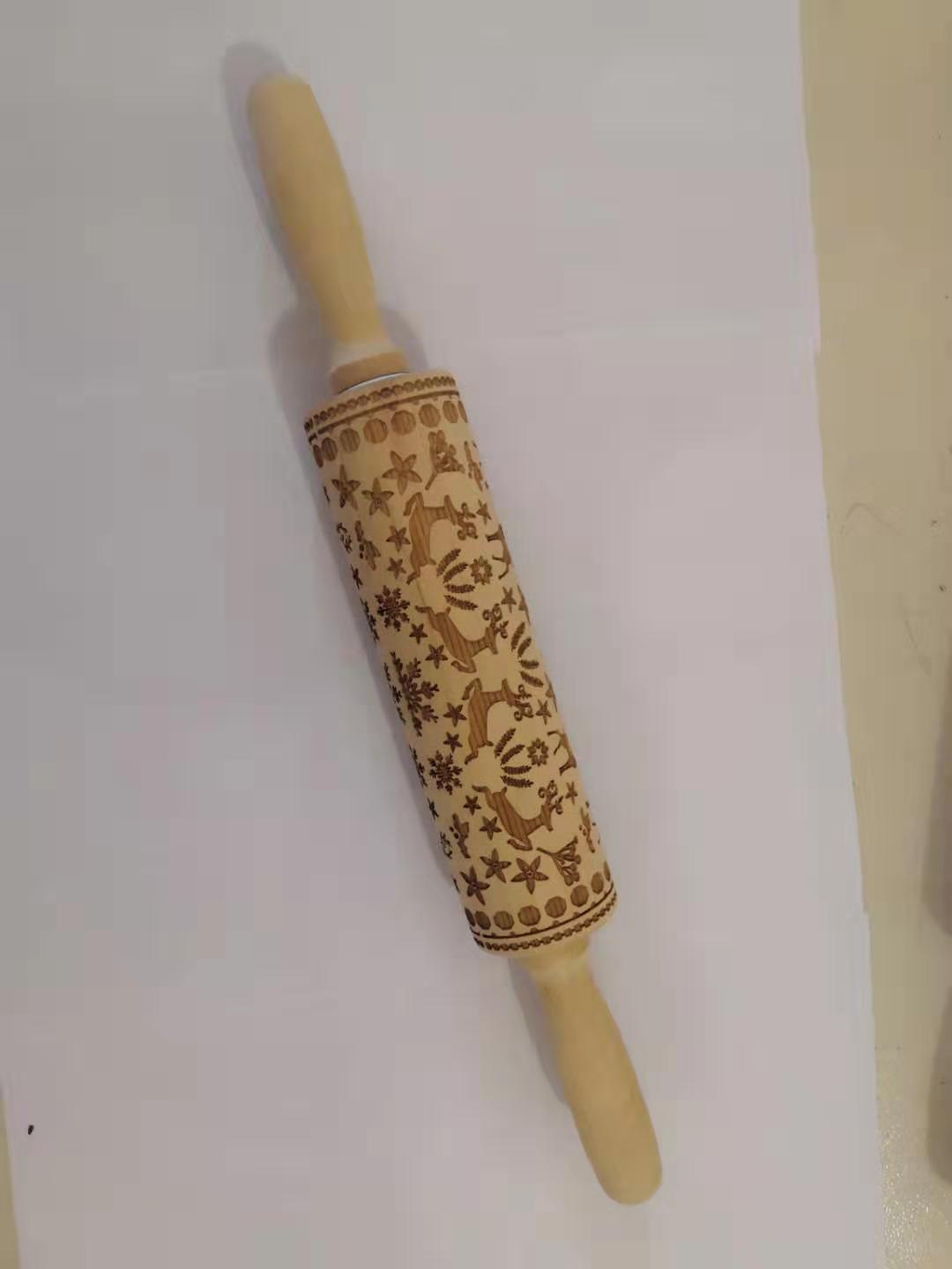 Embossed wooden rolling pin with decorative floral and reindeer pattern for baking