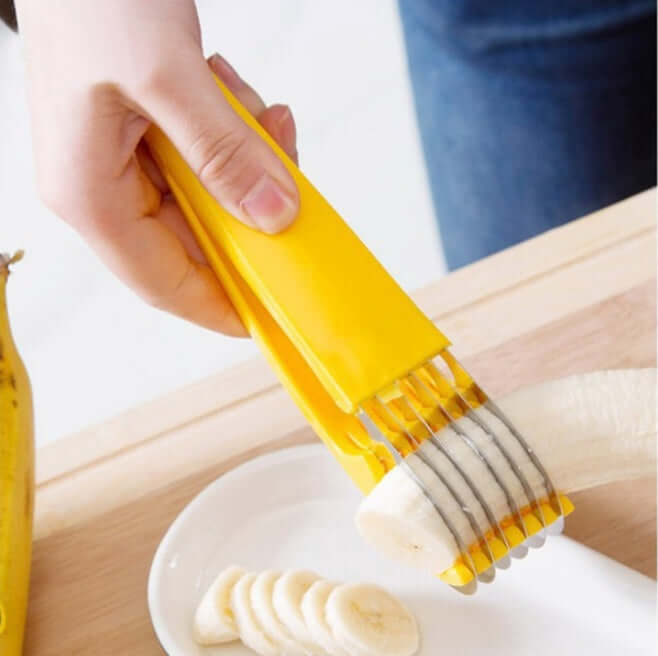 Yellow banana slicer kitchen tool cutting banana into even slices on white plate