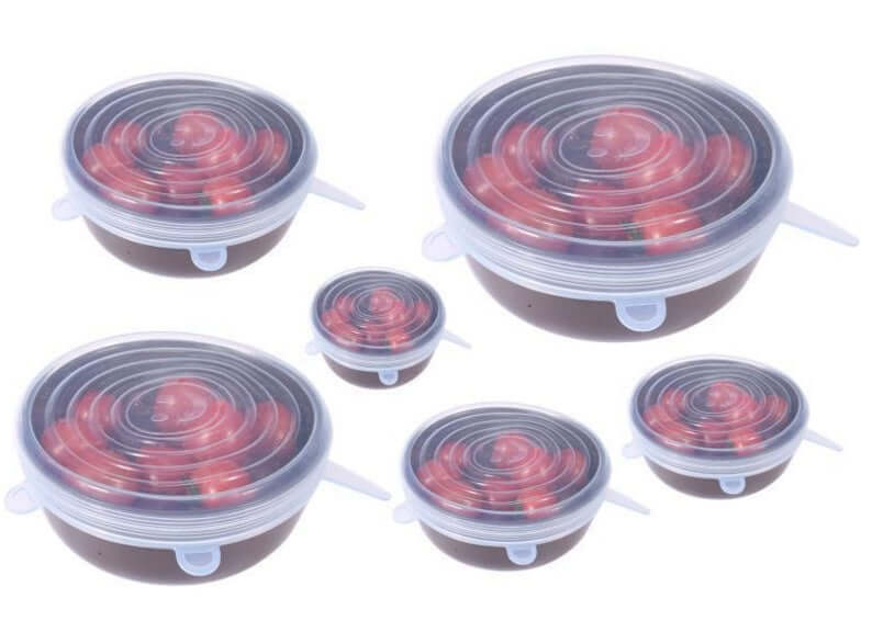 Set of round silicone stretch lids covering bowls of cherry tomatoes, kitchen storage accessory