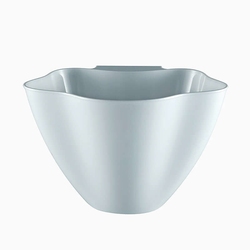 White plastic kitchen bowl with scalloped rim on a plain background