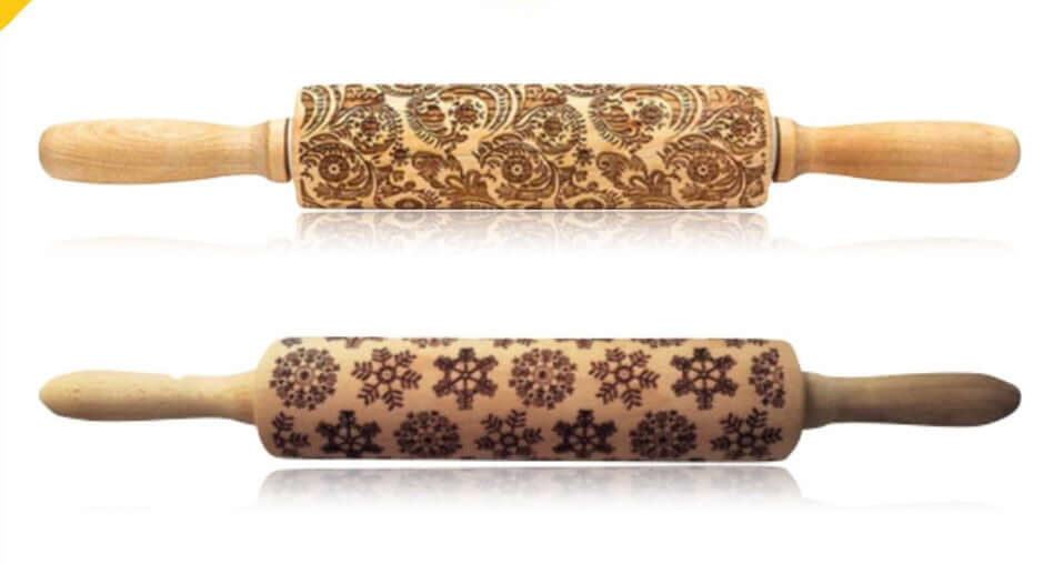 Two wooden embossed rolling pins with floral and snowflake patterns on white background