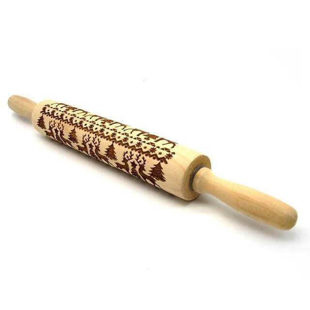 Wooden embossed rolling pin with festive tree and reindeer pattern for baking.