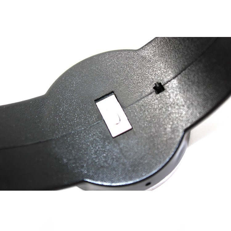 Close-up of a black plastic kitchen tool with metal locking mechanism