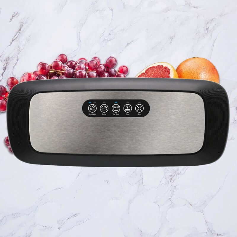 kitchen vacuum sealer machine on marble countertop with grapes and grapefruit