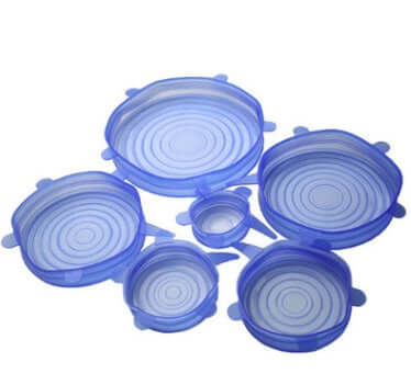 Set of six blue silicone stretch lids for food storage in various sizes on white background