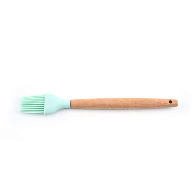 Silicone pastry brush with wooden handle on white background, kitchen utensil