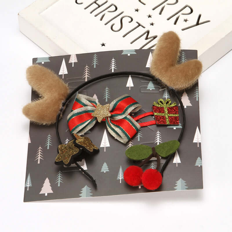 Christmas-themed hair accessories set with antlers, bow, gift, and cherry clips on festive background
