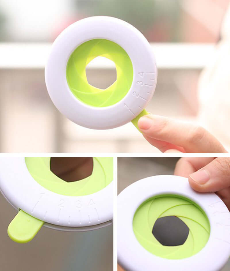 Adjustable green and white kitchen tool with circular opening for measuring or slicing vegetables.