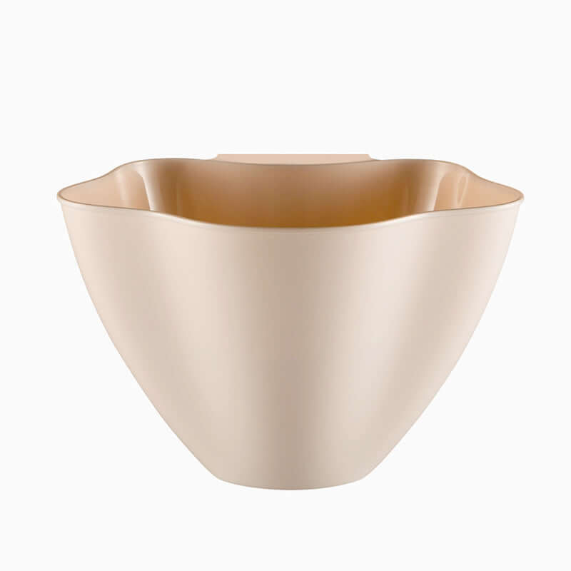 Beige plastic kitchen bowl with wavy rim, modern food storage container
