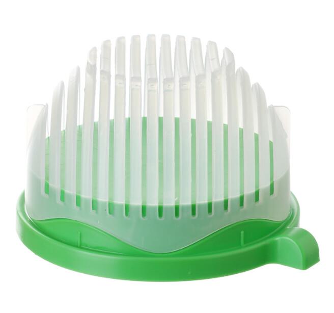 Green and white plastic salad cutter bowl kitchen accessory on white background