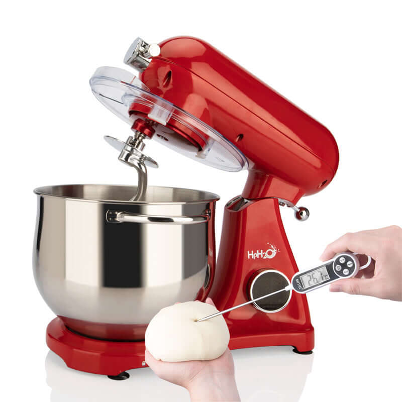 Red stand mixer with stainless steel bowl, dough hook, and hand holding thermometer in dough