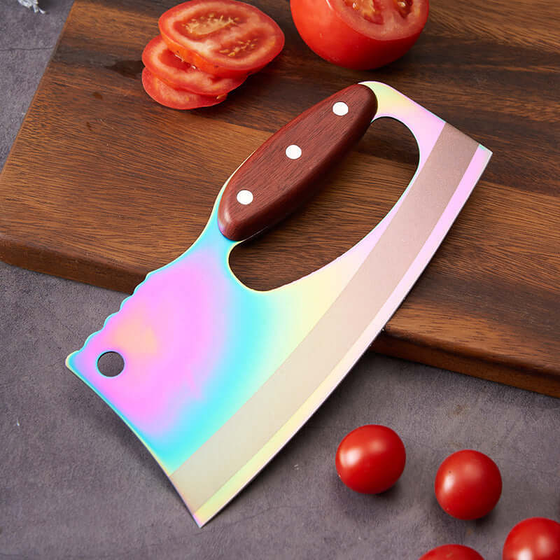 Rainbow cleaver knife with wood handle on cutting board and sliced tomatoes