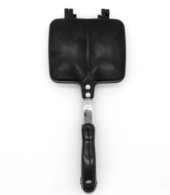 Non-stick sandwich maker with black handle, useful kitchen accessory on white background